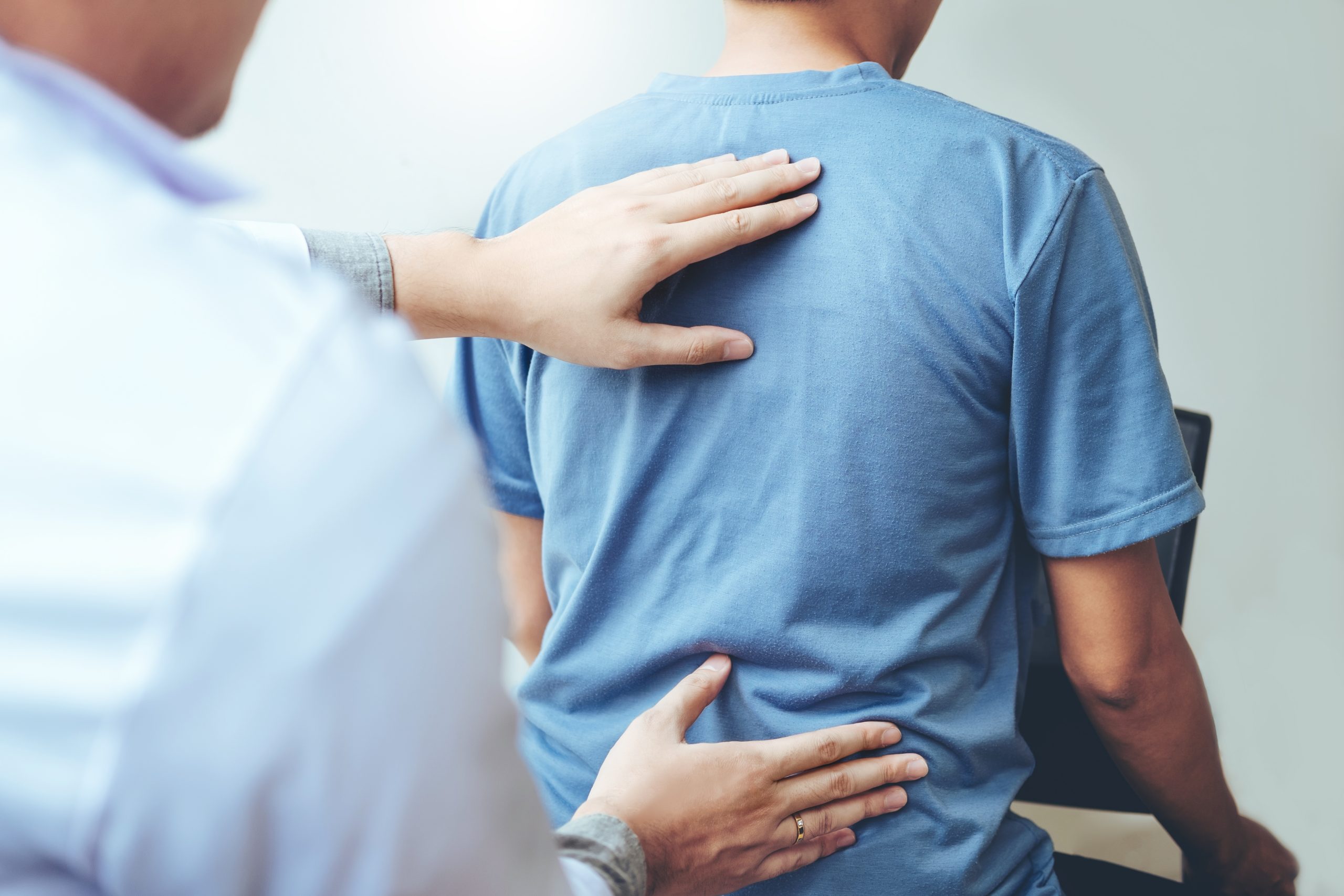 Doctor consulting with patient Back problems Physical therapy co
