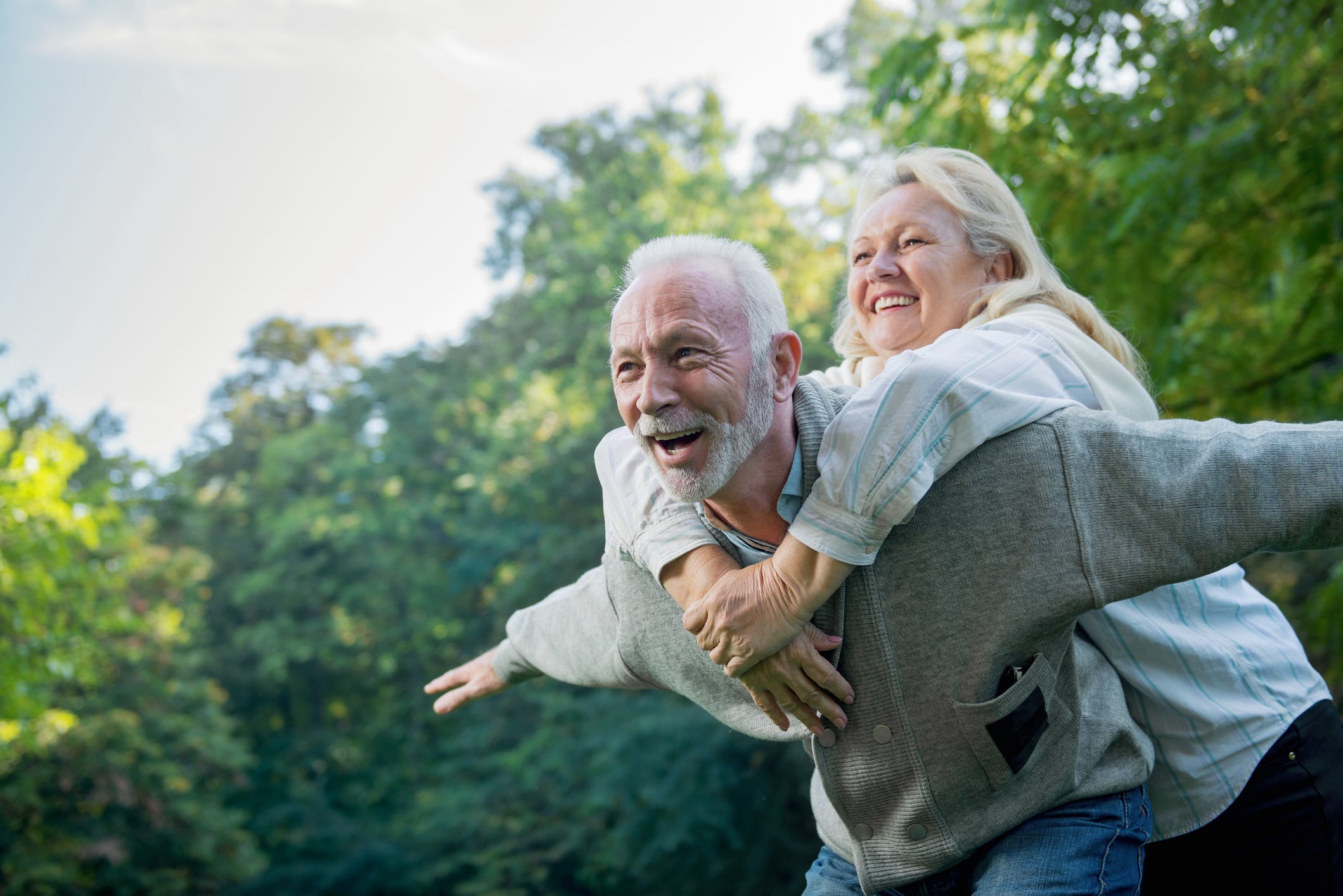 Happy senior couple enjoying active lifestyle supported by DXA scan insights for bone and muscle health.