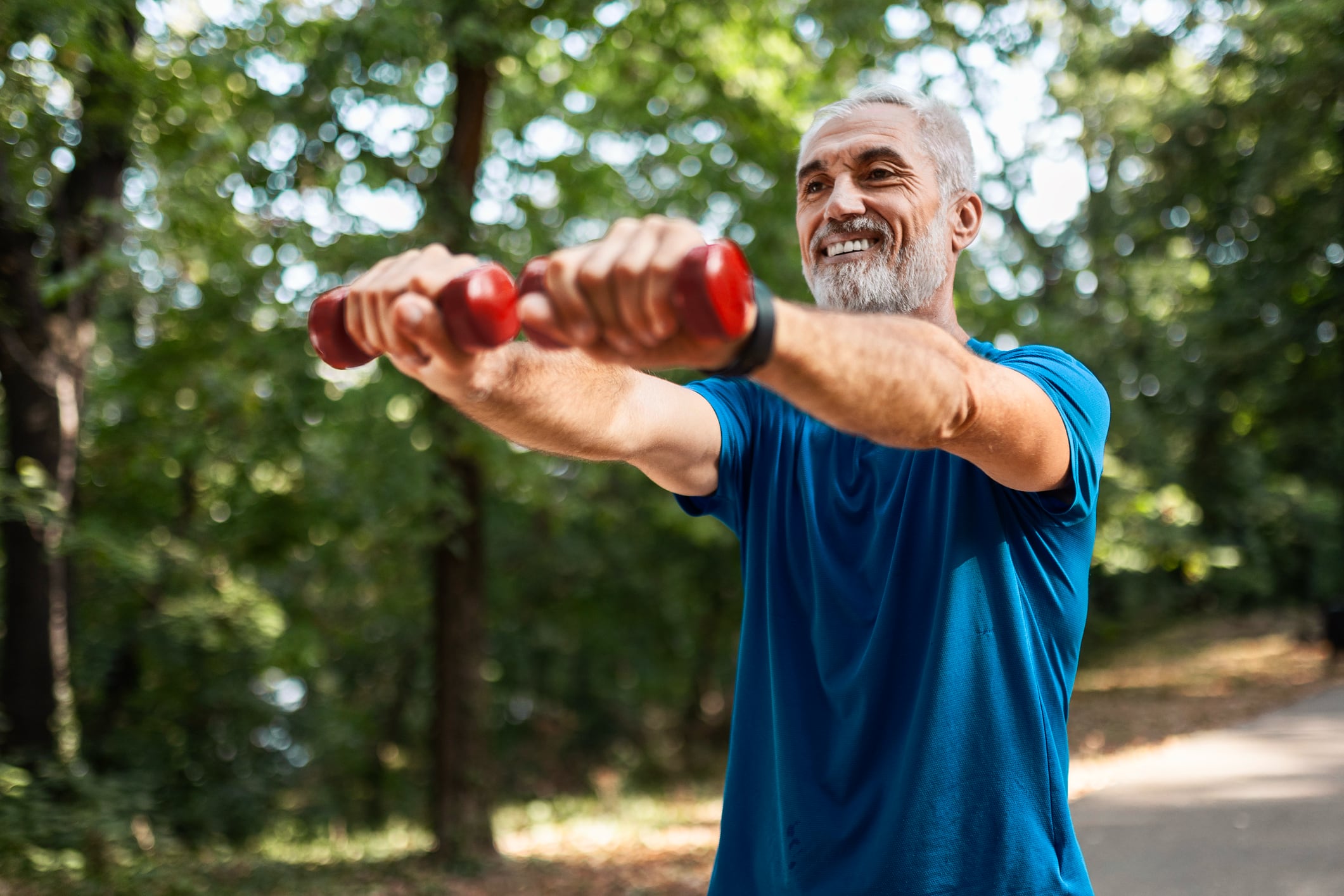 Older man exercising with dumbbells outdoors as part of the Onero bone health program for osteoporosis and osteopenia.